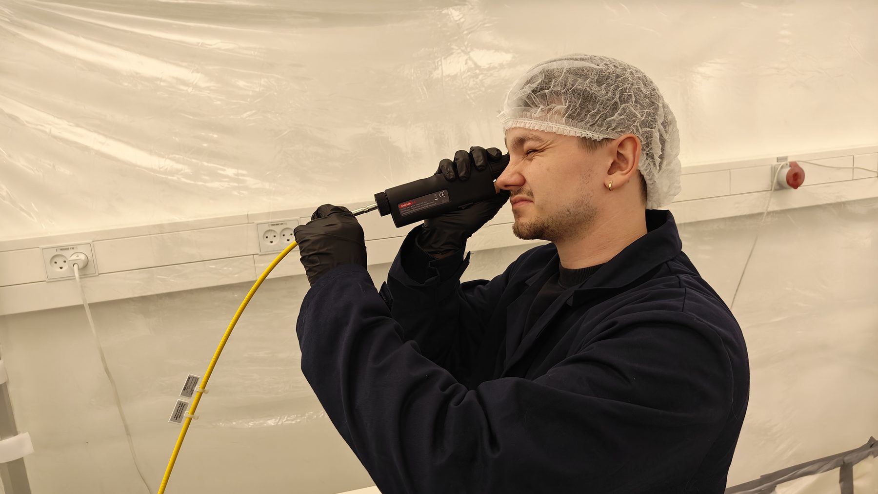 A GreenGuard engineer inspecting a laser fibre in the cleanroom